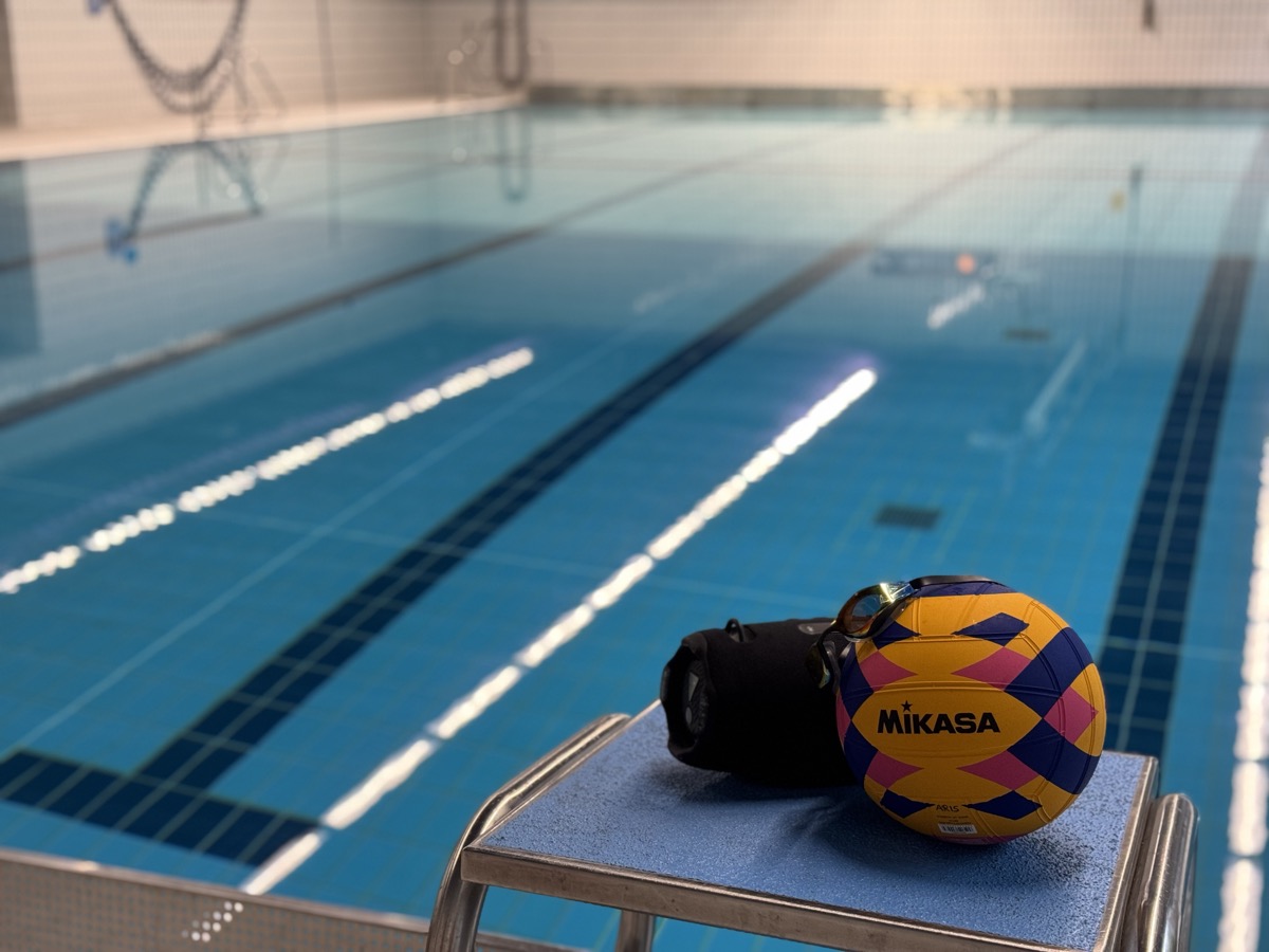 Water polo ball on the pool edge before training